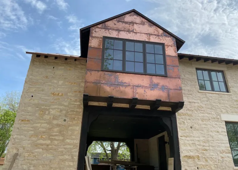 Copper metal panel facade on a stone building for Metal Roof Coating in Gateway