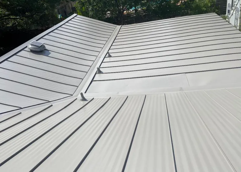 Solar attic fan installed on a metal roof for Roof Ventilation in Gateway